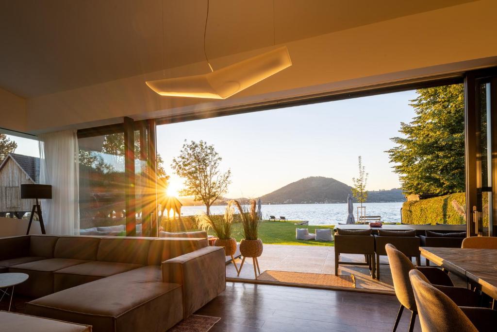 a living room with a view of the water at Haus Sommerfrische in Weyregg