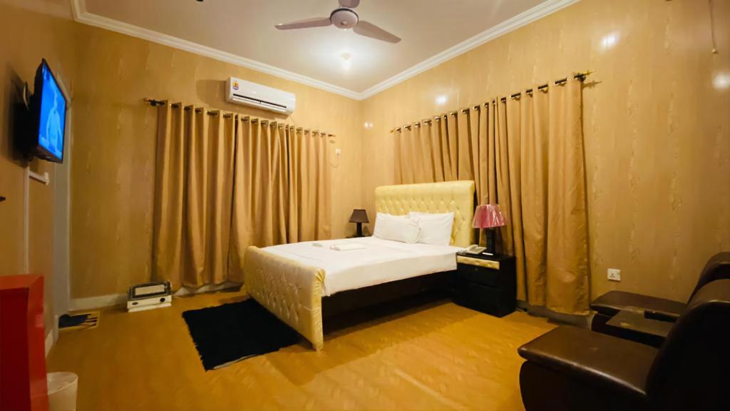 En eller flere senger på et rom på Rio Inn Guest House