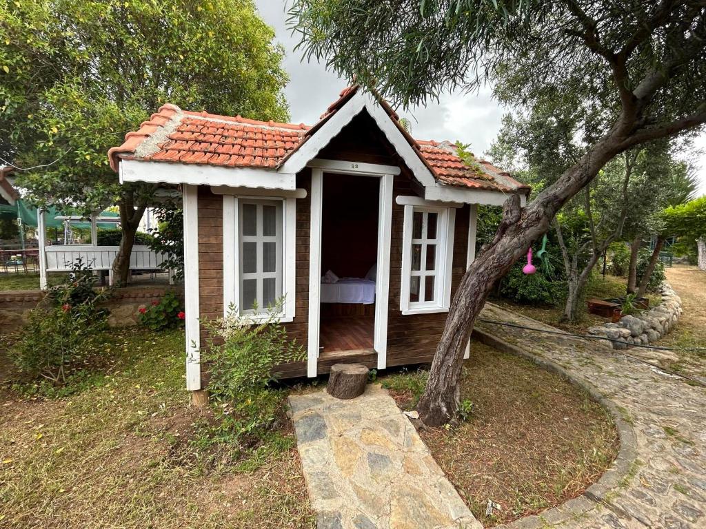 a small house with a porch in a yard at Sweet horses HH1 in Didim