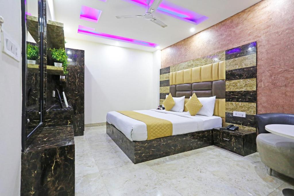 a bedroom with a bed and a shower and a sink at Hotel Grand LA CASA Near IGI airport in New Delhi