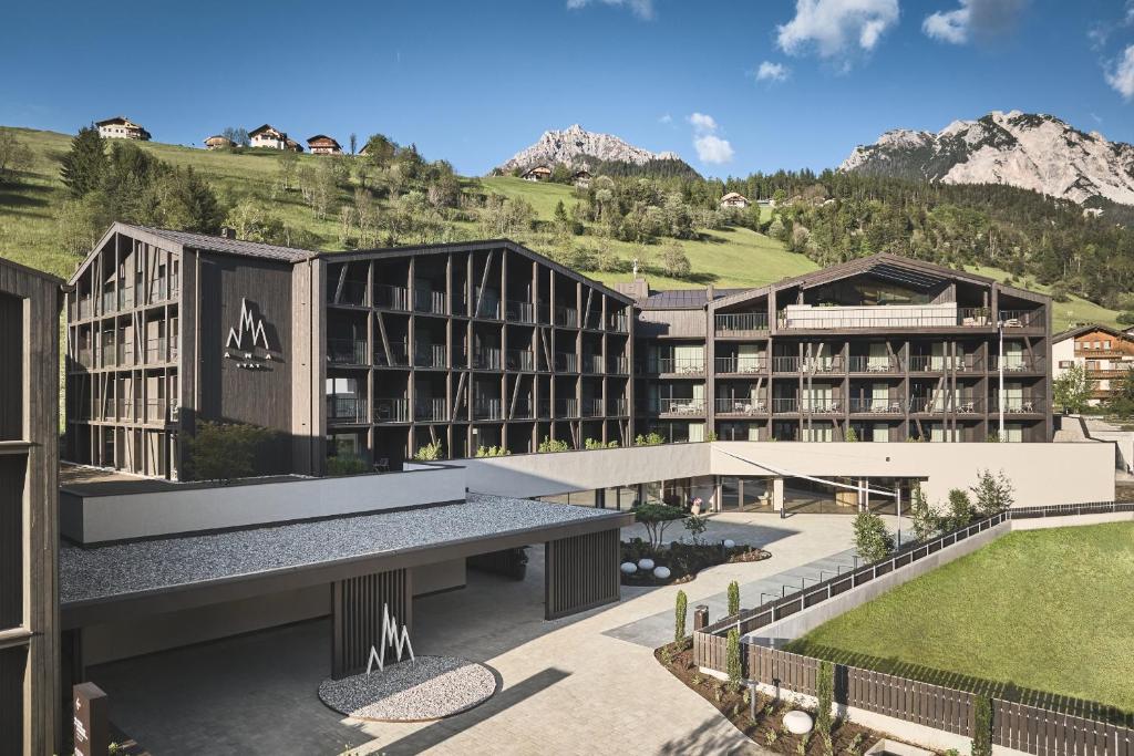 a rendering of a resort with mountains in the background at AMA Stay in San Vigilio Di Marebbe