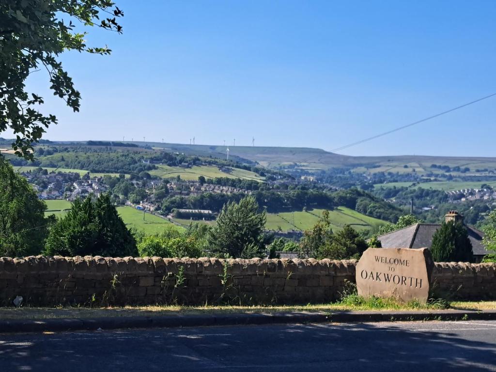a sign for the town of oxfordwich with a view of the hills at Oakworth in Oakworth