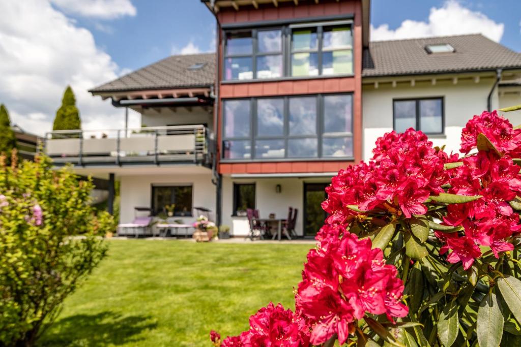 a house with pink flowers in front of it at Am oberen Bühl in Furtwangen