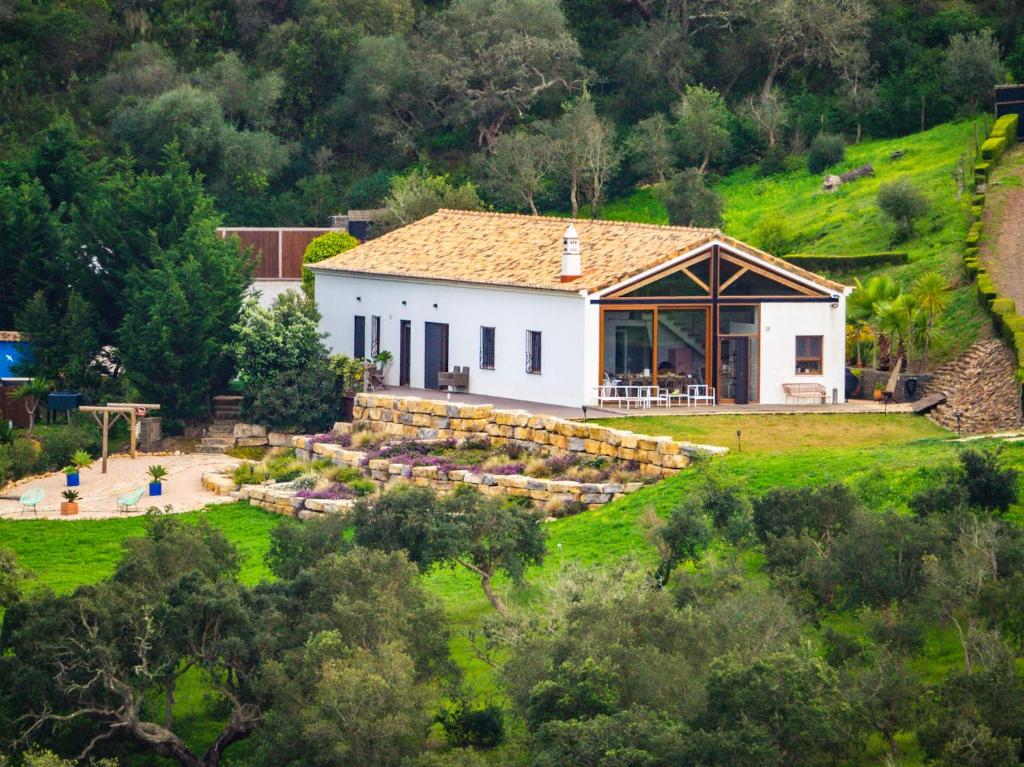 a white house on a hill with a garden at Salthouse Portugal - Stylish Duplex Apartment in Aljezur