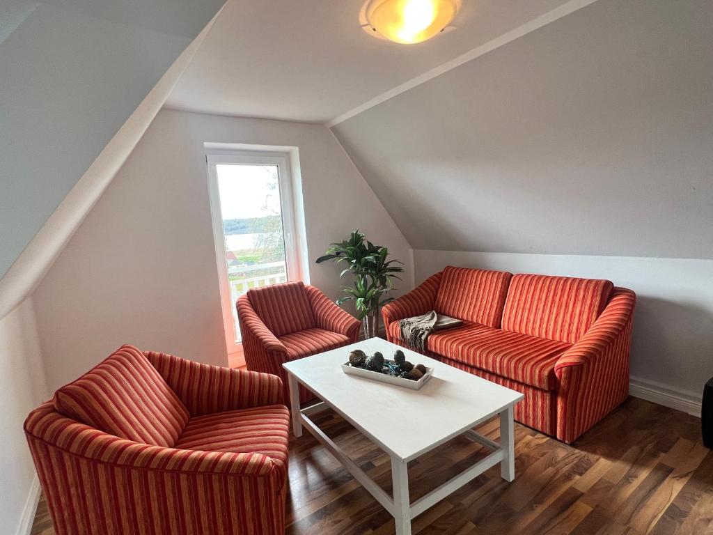 ein Wohnzimmer mit 2 Stühlen und einem Tisch in der Unterkunft Haus Godewind in Binz