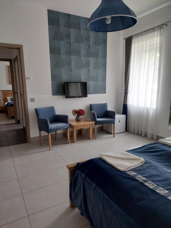 Posteľ alebo postele v izbe v ubytovaní Hédervári Lovas Vendégház