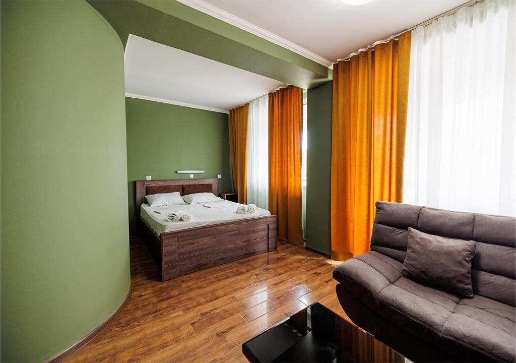 提比里斯的住宿－瑪戈薩樂比第比利斯中心酒店，客厅配有沙发和1张床