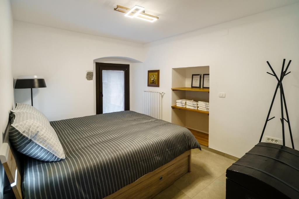 a bedroom with a bed and a television in it at Guest House Žerjal in Podnanos