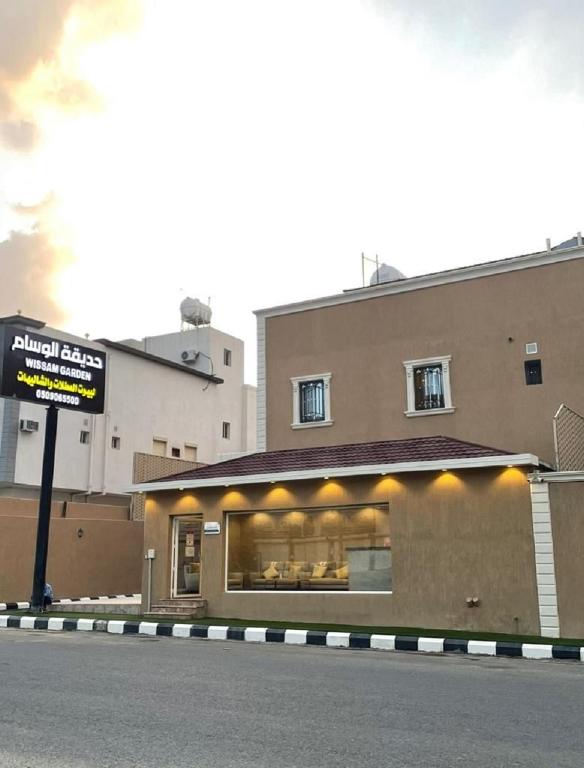 una tienda con un cartel delante de un edificio en منتجع حديقة الوسام en Taif