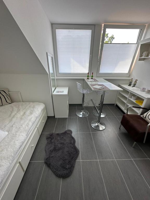 a bedroom with a bed and a desk and a table at Appartement 2 in Bersenbrück
