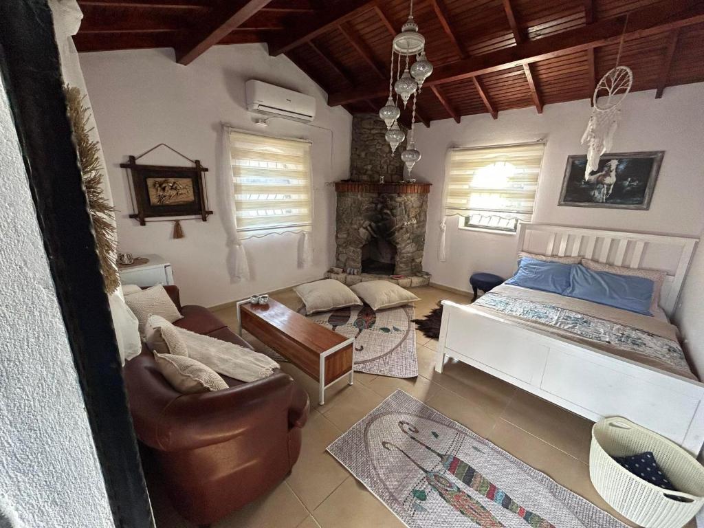 a living room with a bed and a couch at sweet horses ST6 in Didim