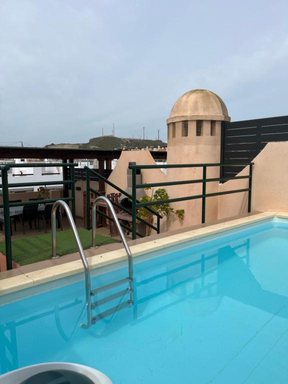 a swimming pool on the roof of a building at ÁTICO Paraíso Beach con piscina privada in Vera