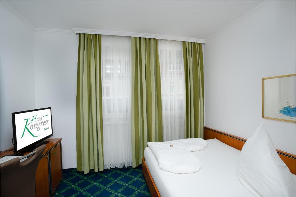 Postel nebo postele na pokoji v ubytování Hotel Kongress