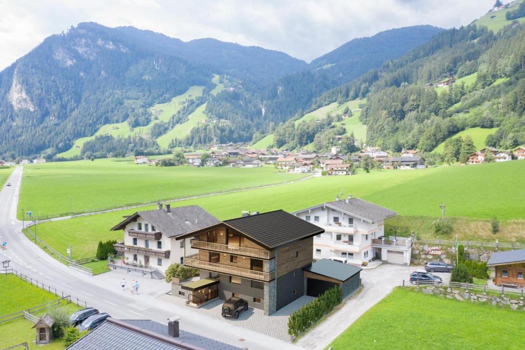 an aerial view of a house in a valley with mountains at Cozy Loft in the Alps of Zillertal in Schwendau