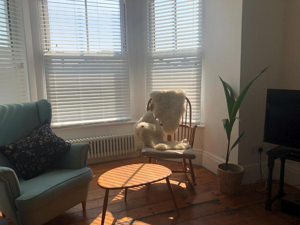 a living room with a chair with stuffed animals on it at The Nest, Central Falmouth, 10 mins to the beaches and off street parking in Falmouth