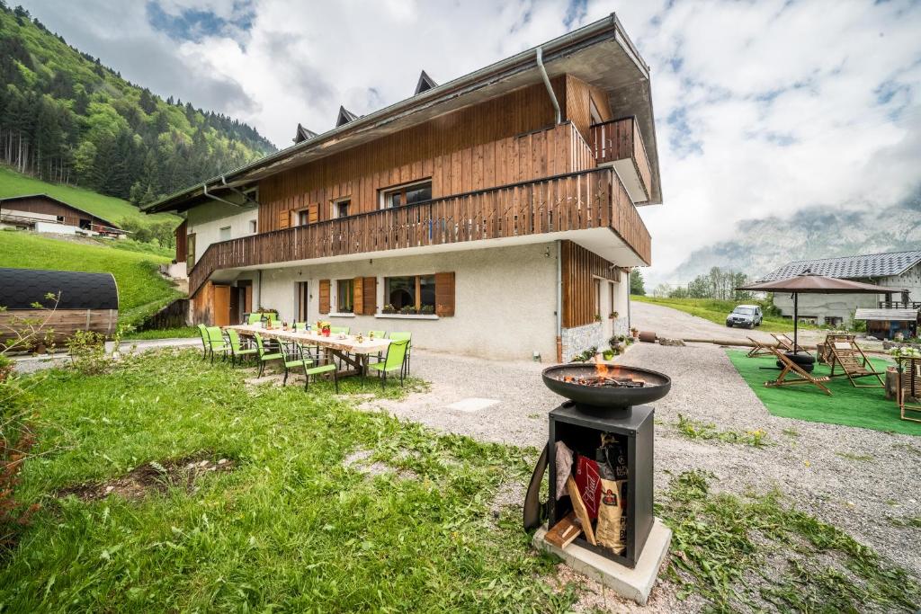 a house with a grill in front of it at Coeur de Charmy - 10 personnes in Abondance