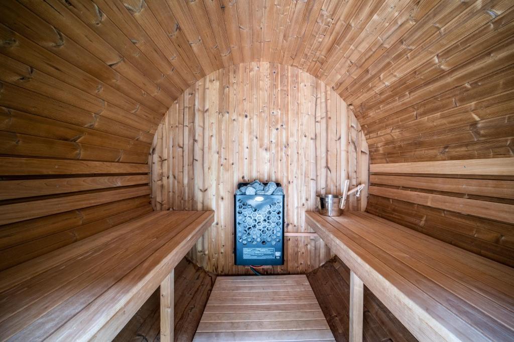 an inside of a wooden sauna with a blue boiler at Coeur de Charmy - 10 personnes in Abondance