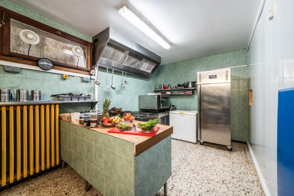 a kitchen with a counter with fruits and vegetables on it at Coeur de Charmy - 10 personnes in Abondance