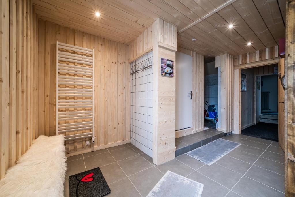 a sauna with wooden walls and a tile floor at Coeur de Charmy - 10 personnes in Abondance