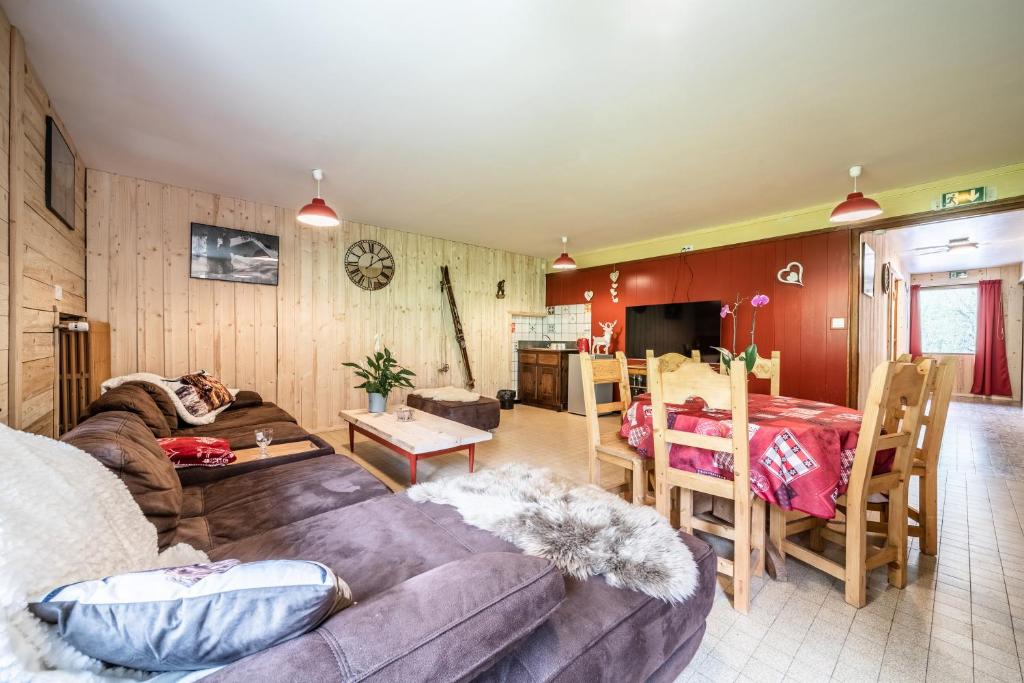 a living room with a couch and a table at Coeur de Charmy - 10 personnes in Abondance