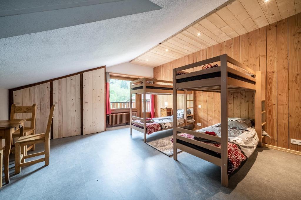a room with two bunk beds and a table at Coeur de Charmy - 10 personnes in Abondance
