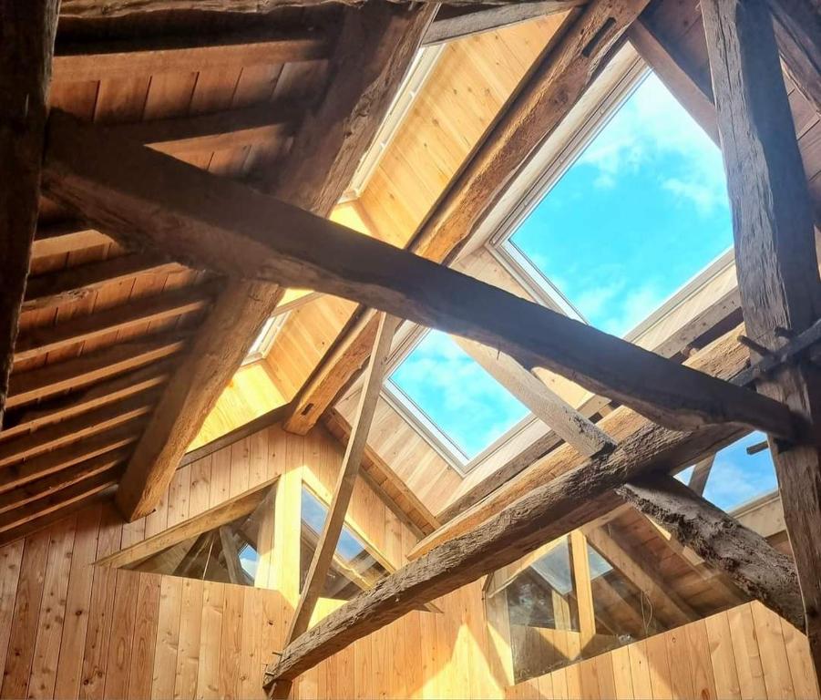 een dak van een houten gebouw met ramen bij Cerf, ouvre-moi B&B in Rochefort