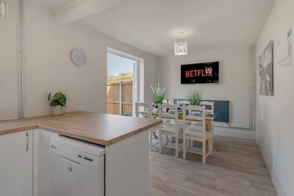 a kitchen and dining room with a table and chairs at 4 bedroom Pitchford in Earlham