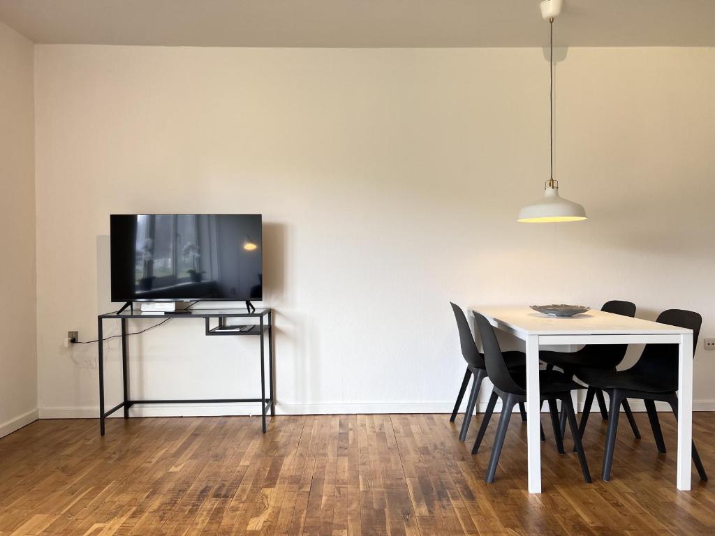 comedor con mesa y TV en la pared en One Bedroom Apartment In Rdovre, Trnvej 41b, 2, en Rødovre