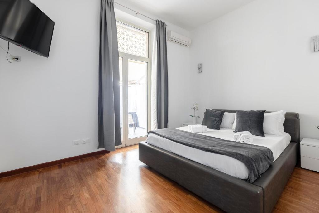 a bedroom with a large bed and a television at Art House Centro Storico Luxury Apartment in Rome