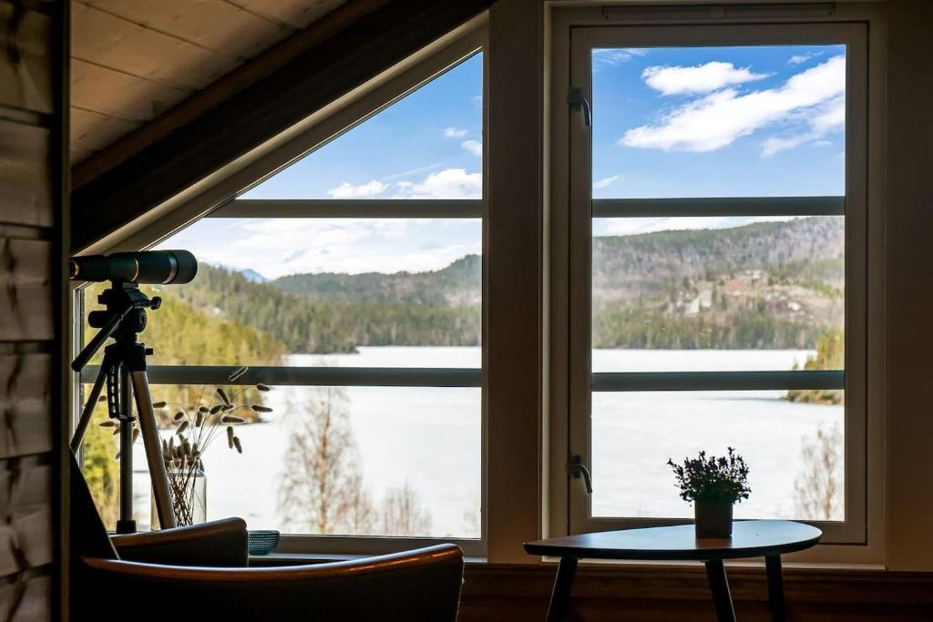 a large window with a view of a lake at Hytte Eribo in Lona