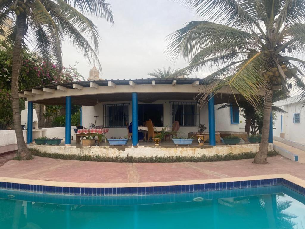 a house with a swimming pool in front of a house at Yannick House in Nditarh