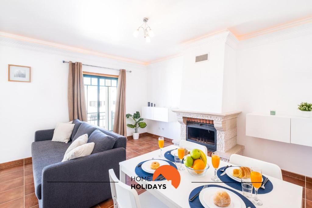 a living room with a couch and a table with fruit on it at #020 Medronheira by Home Holidays in Albufeira