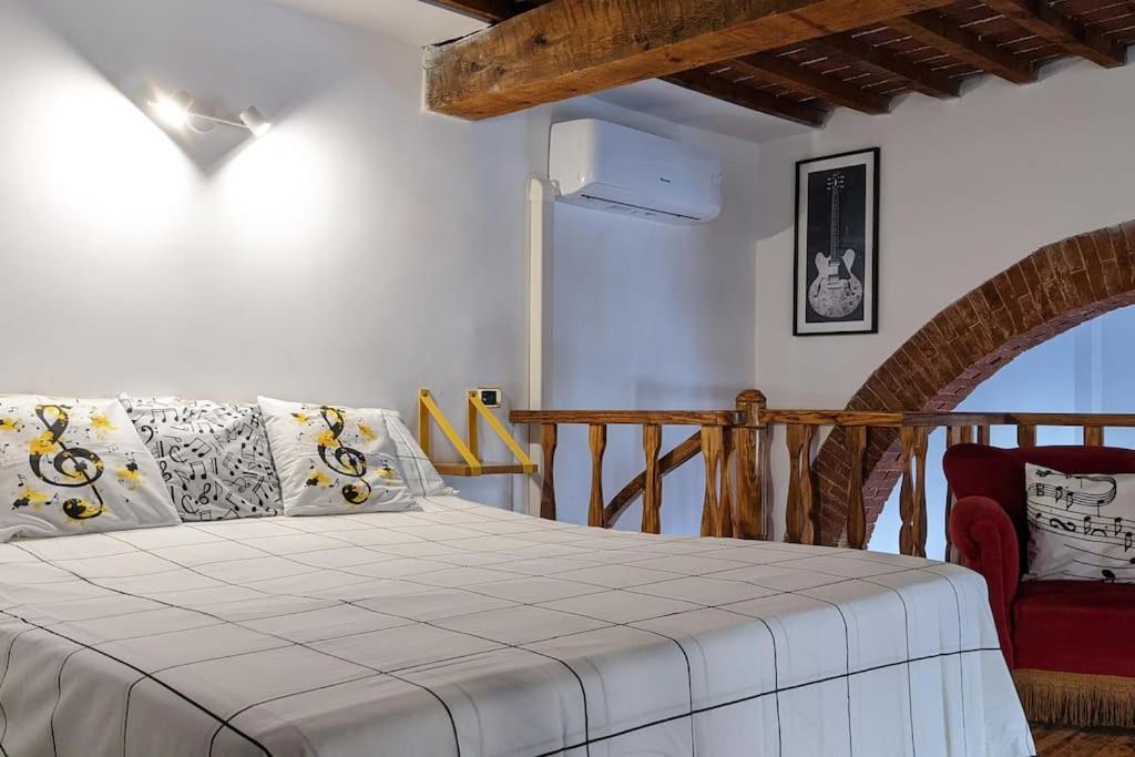 En eller flere senge i et værelse på Casa Armonia