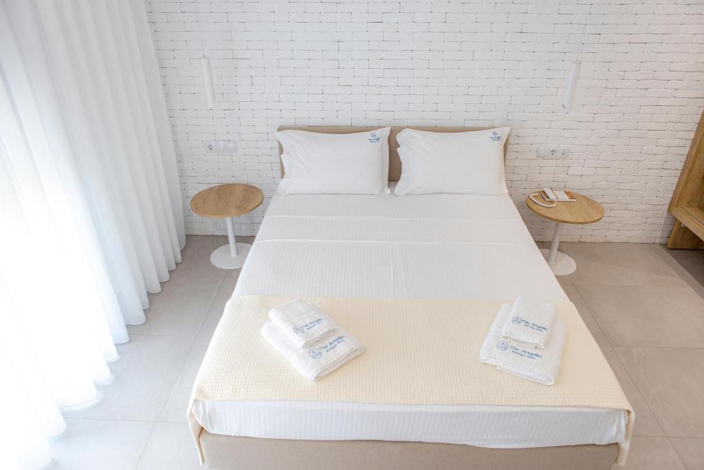 A bed or beds in a room at The Angeliki Boutique Hotel