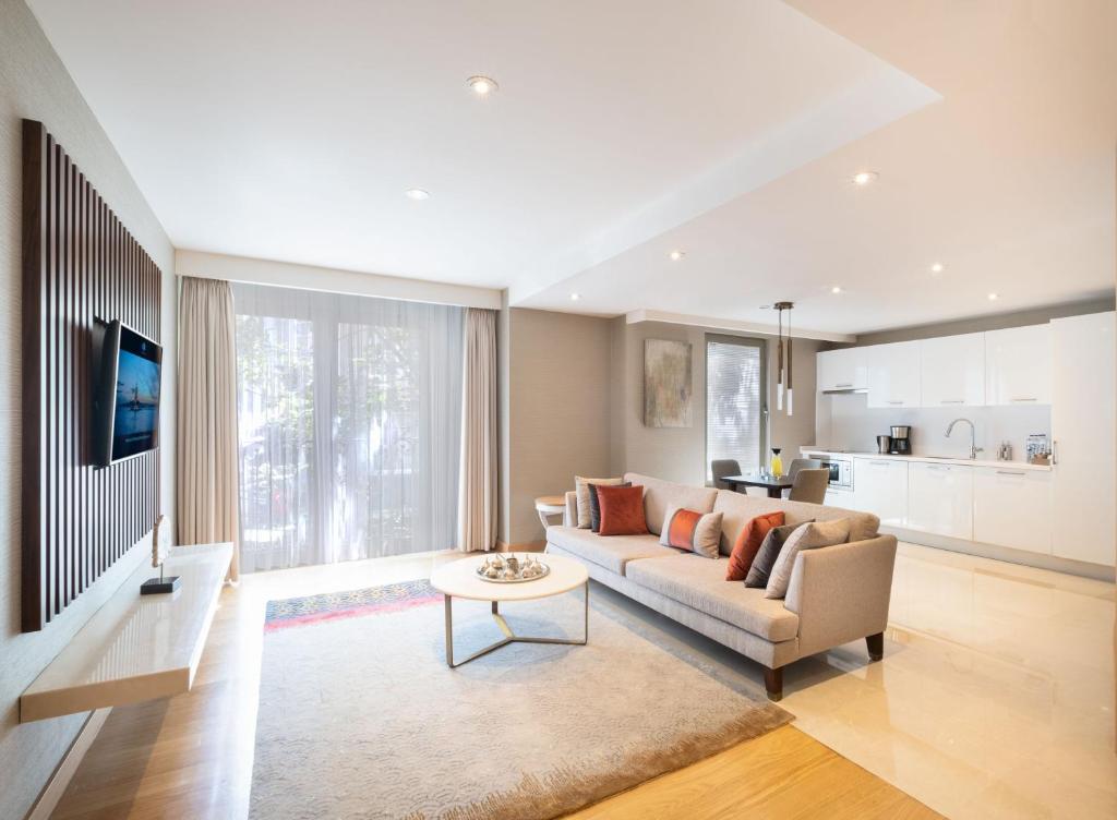 a living room with a couch and a table at CVK Park Bosphorus Hotel Istanbul in Istanbul