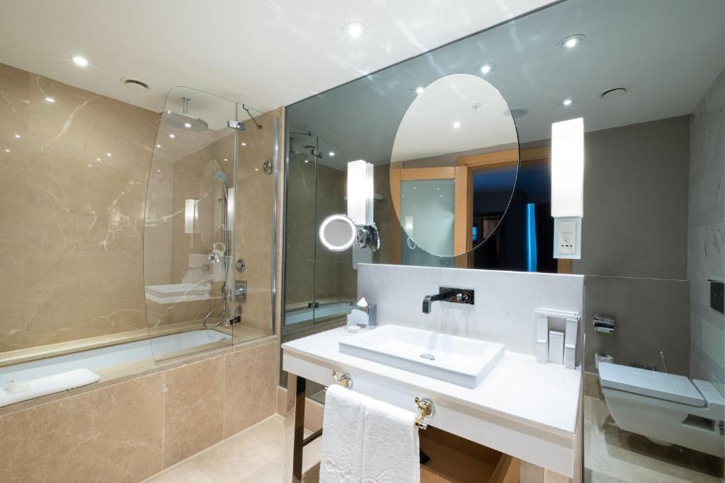 a bathroom with a sink and a shower at CVK Park Bosphorus Hotel Istanbul in Istanbul