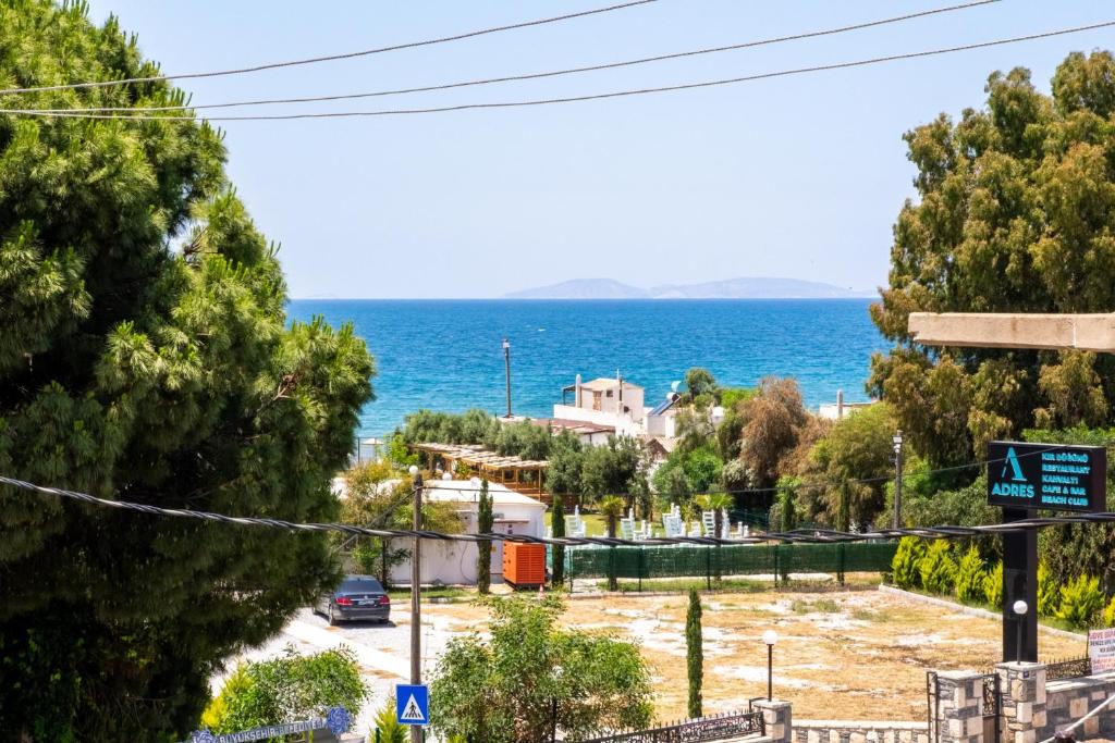 a view of the ocean from a street at Flat w Sea View Terrace 1 min to Beach in Didim in Didim