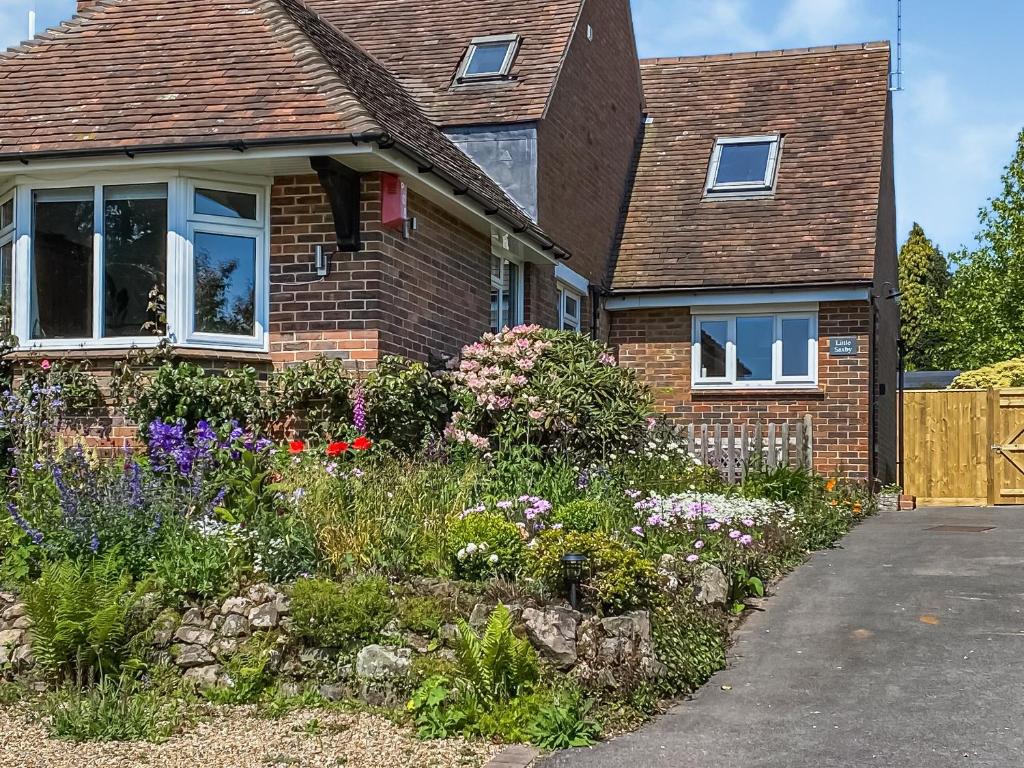 a brick house with a garden in front of it at Little Saxby in Crowborough