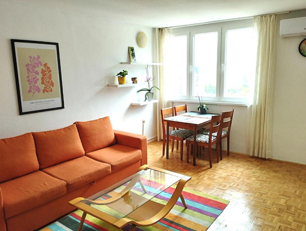 a living room with a couch and a table at Apartman Amigo-Free public parking in Sarajevo