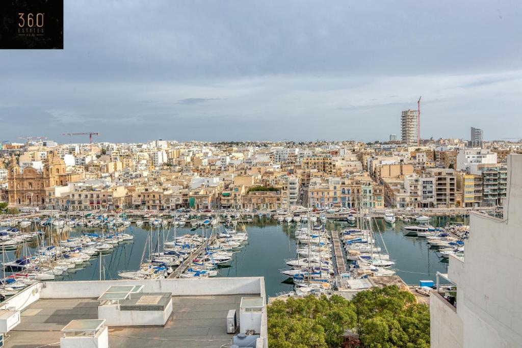 a view of a harbor with boats in the water at Stunning 2BR penthouse with beautiful harbour view BY 360 Estates in Tal-Pietà