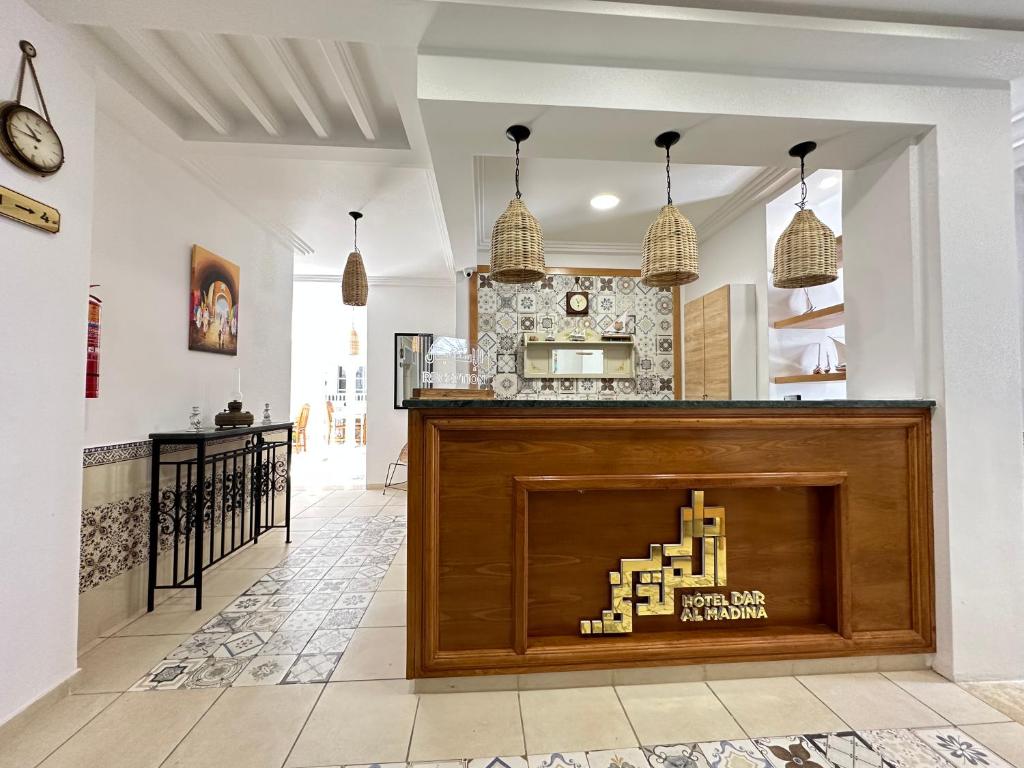 a store front with a wooden counter in a room at Hotel Dar Al Madina in Mahdia