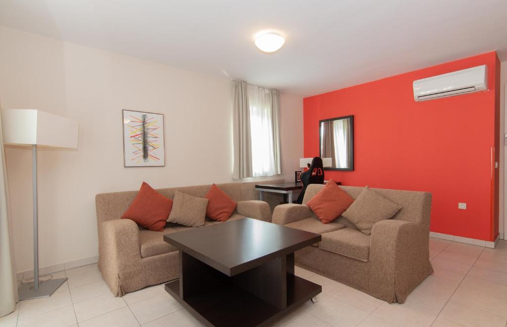 a living room with a couch and a table at Residence Marina Garbin Apartment in Portorož