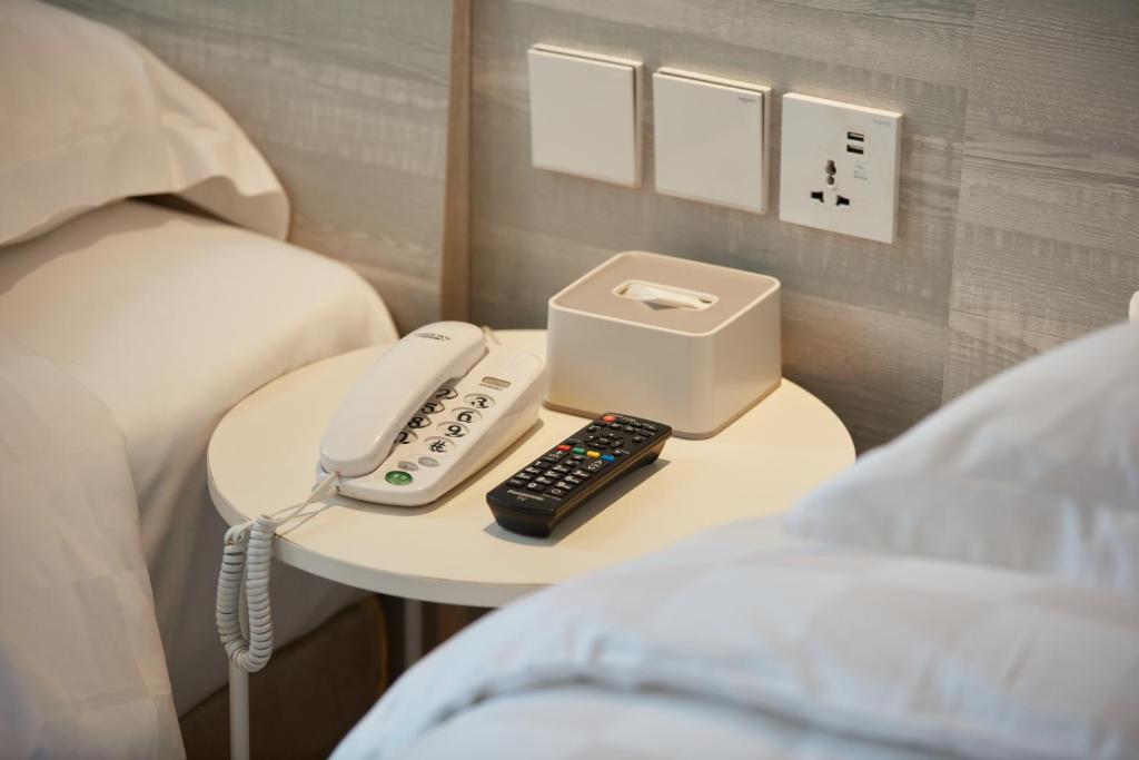 Postel nebo postele na pokoji v ubytování Ole Tai Sam Un Hotel