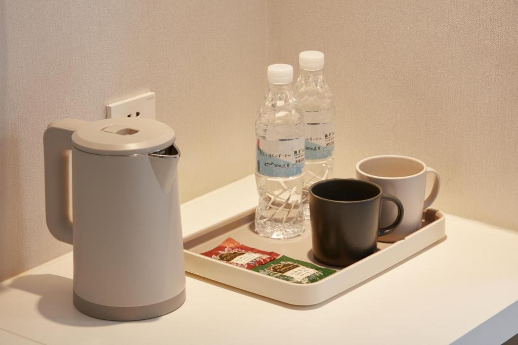 Příslušenství pro přípravu čaje a kávy v ubytování Ole Tai Sam Un Hotel