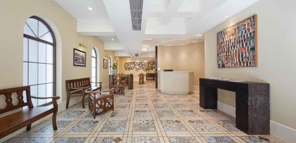 a lobby with chairs and a fireplace in a building at Ole Tai Sam Un Hotel in Macau