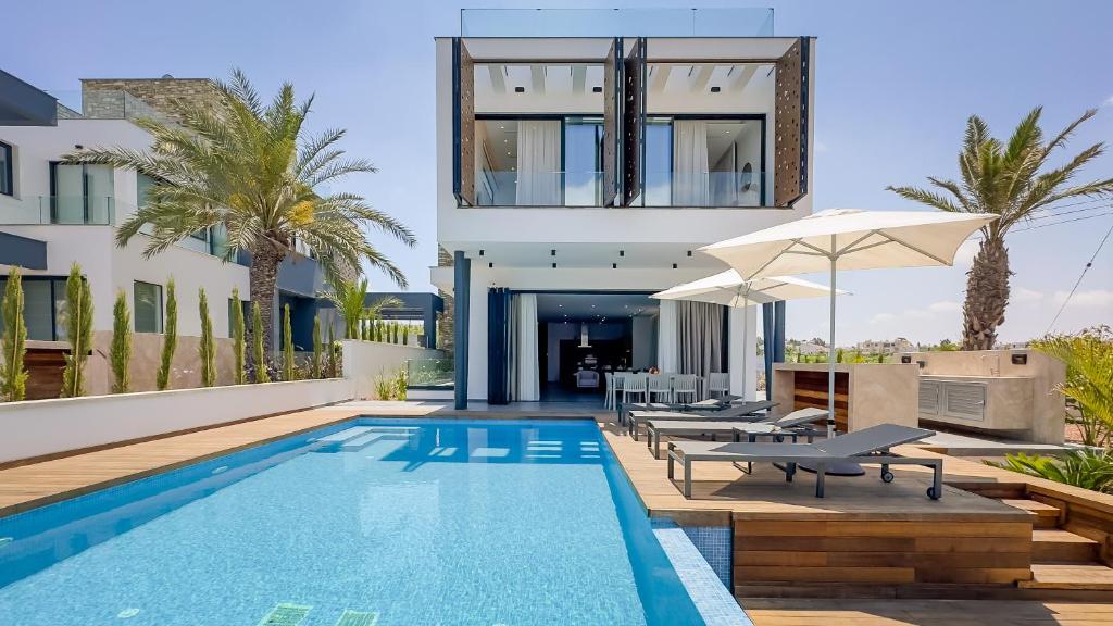 una villa con piscina e una casa di Sunrise Beachfront Villas - Villa 1 a Paralimni