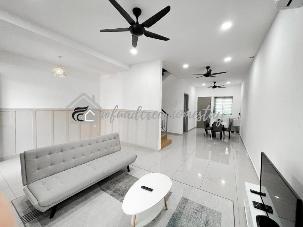 - un salon avec un canapé et un ventilateur de plafond dans l'établissement Jitra Fuad's Crew Homestay, à Jitra