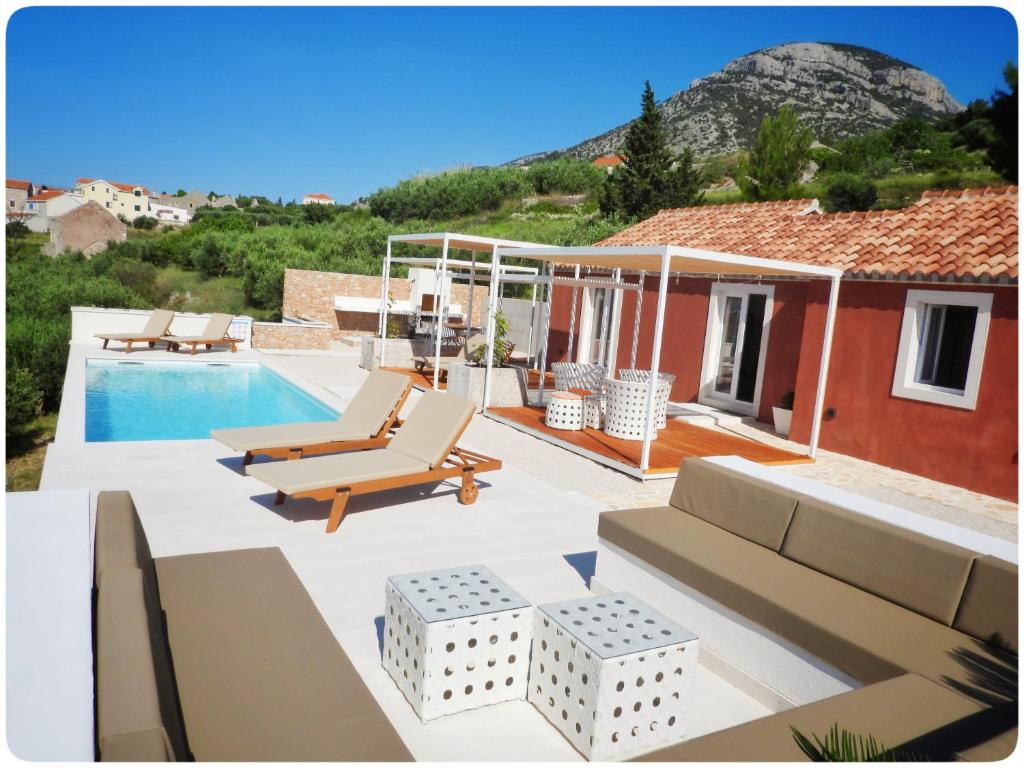 a villa with a swimming pool and a house at Modern Mediterranean Oasis - Villa Bolka in Bol