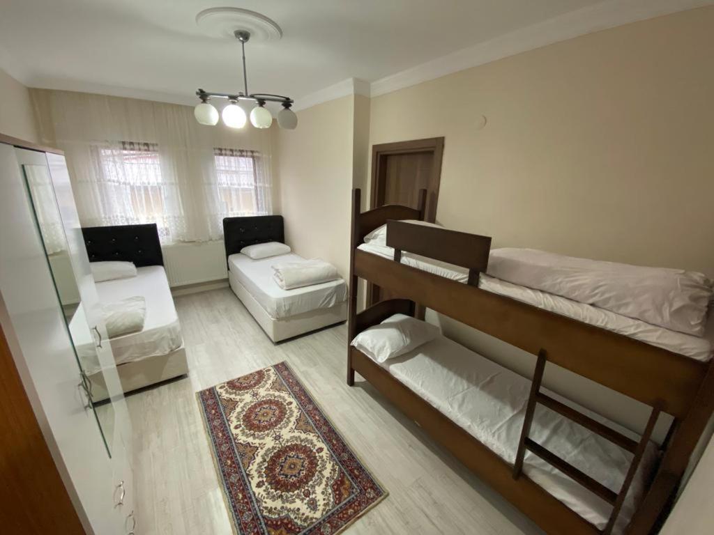 a room with two bunk beds and a living room at Talipoğlu Apart in Uzungol