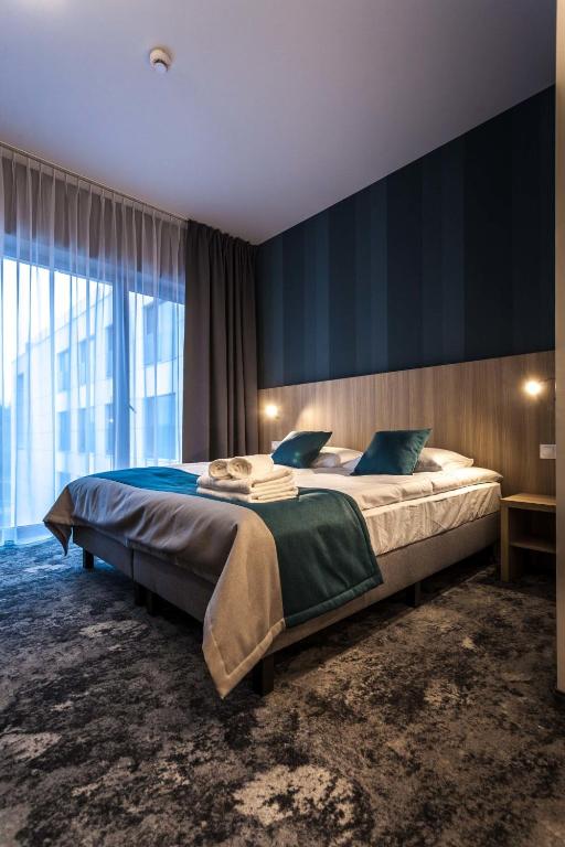 Postel nebo postele na pokoji v ubytování Hotel Zatoka